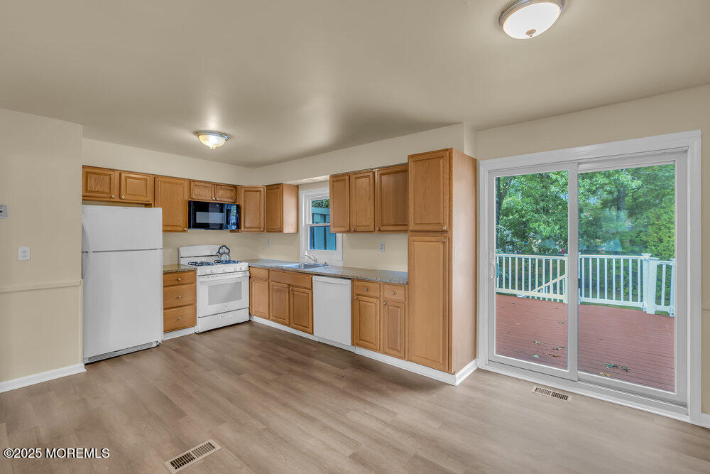 32 Pine Tree Drive Bayville, NJ 08721 - Photo 18 of 63 a kitchen with a refrigerator sink and microwave