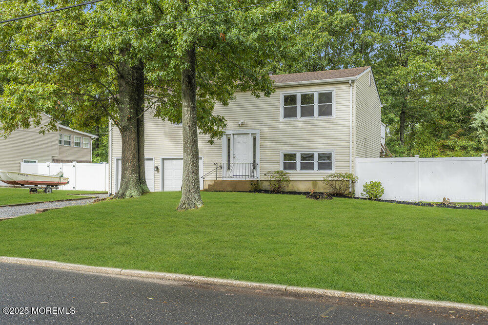 32 Pine Tree Drive Bayville, NJ 08721 - Photo 2 of 63 front view of a house with a yard