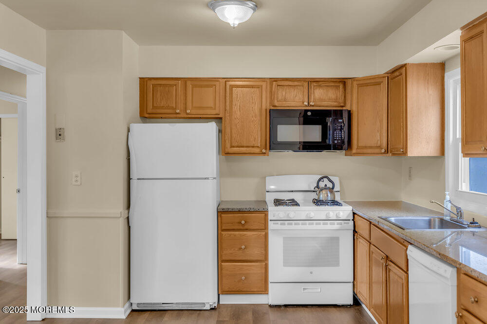 32 Pine Tree Drive Bayville, NJ 08721 - Photo 22 of 63 a kitchen with a sink a stove top oven and refrigerator