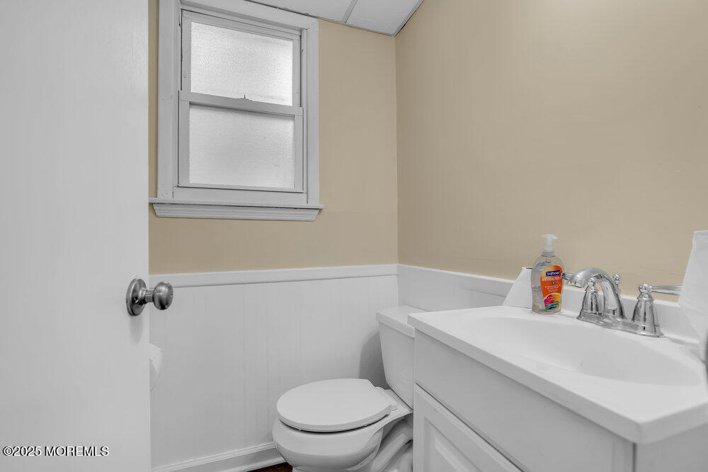 32 Pine Tree Drive Bayville, NJ 08721 - Photo 27 of 63 a bathroom with a toilet sink vanity and window