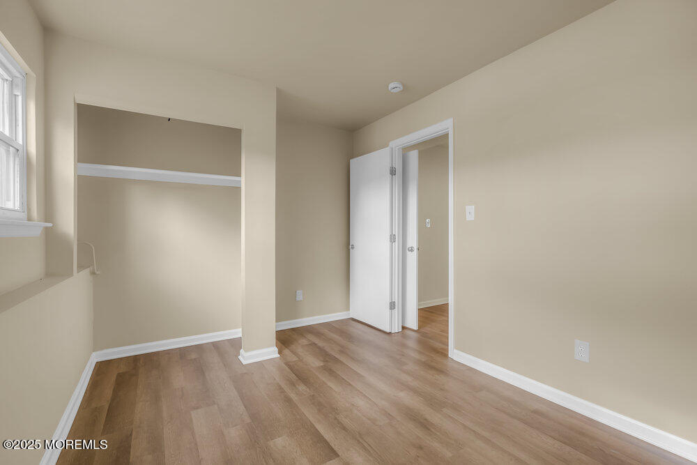 32 Pine Tree Drive Bayville, NJ 08721 - Photo 28 of 63 a view of an empty room with wooden floor and closet