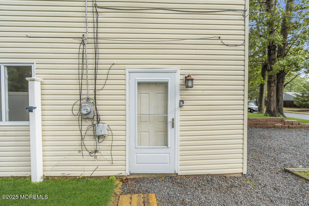 32 Pine Tree Drive Bayville, NJ 08721 - Photo 46 of 63 a view of a white house with a white door