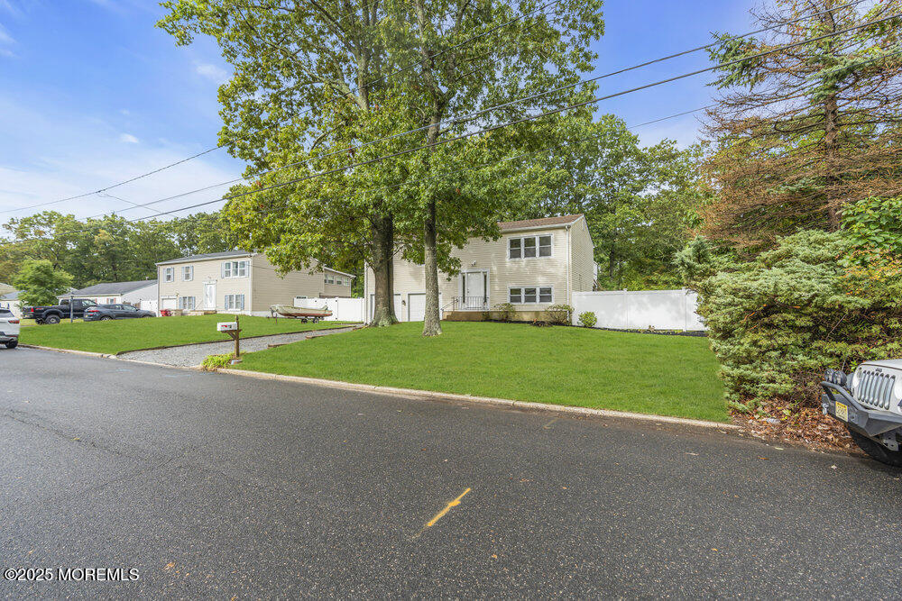 32 Pine Tree Drive Bayville, NJ 08721 - Photo 8 of 63 a view of a house with a big yard and large trees