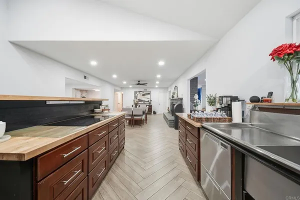 a kitchen with stainless steel appliances granite countertop a sink counter space and cabinets