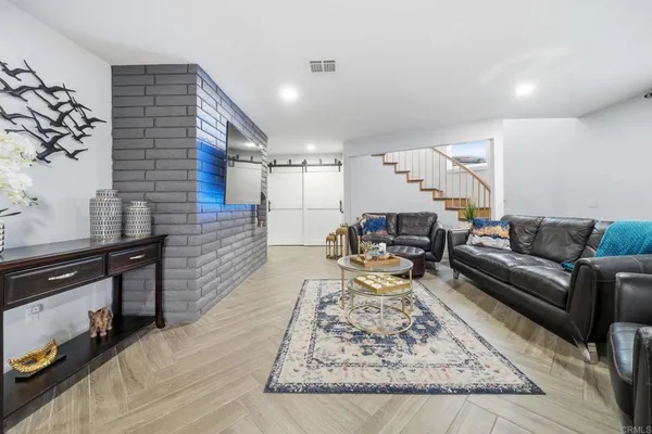 a living room with furniture rug and window