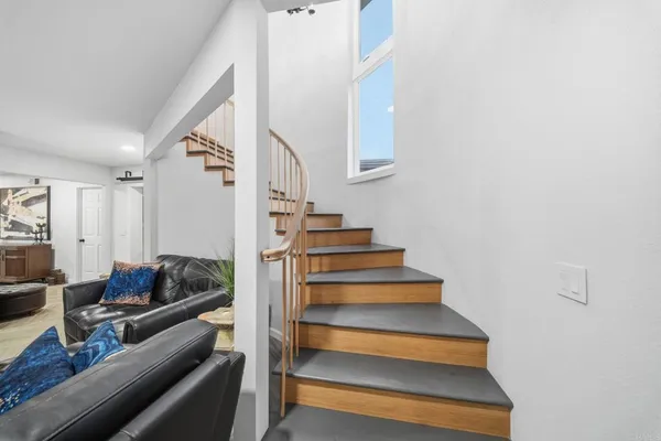 a view of gym equipment and living room with furniture