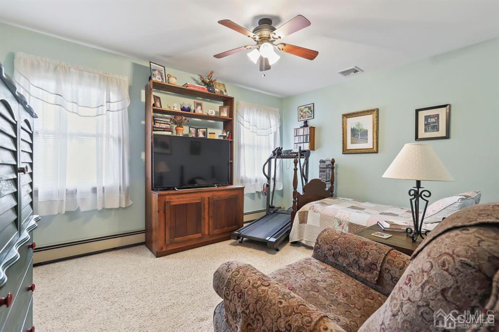 10 Bennett Road Old Bridge, NJ 07747 - Photo 14 of 35 a bedroom with a bed and a chandelier