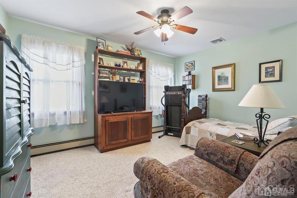 10 Bennett Road Old Bridge, NJ 07747 - Photo 19 of 35 a bedroom with a bed couches and a flat tv screen