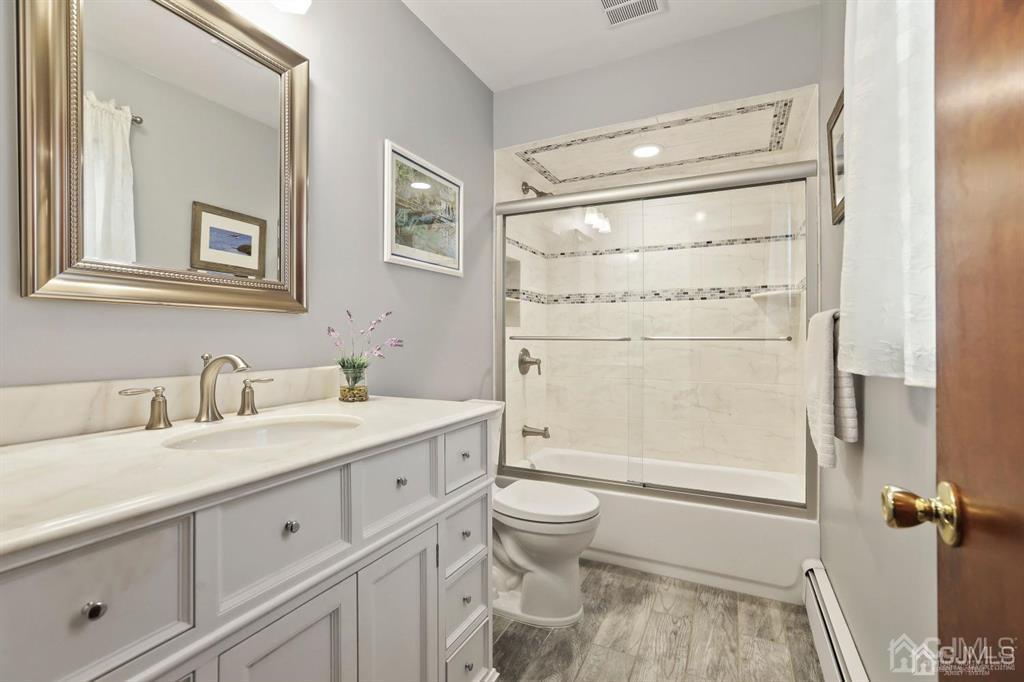 10 Bennett Road Old Bridge, NJ 07747 - Photo 20 of 35 a bathroom with a sink a toilet and shower