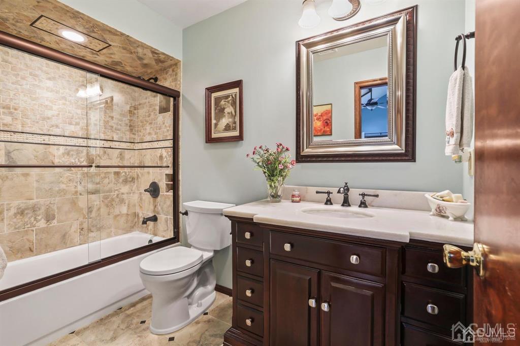 10 Bennett Road Old Bridge, NJ 07747 - Photo 22 of 35 a bathroom with a toilet a sink and a mirror