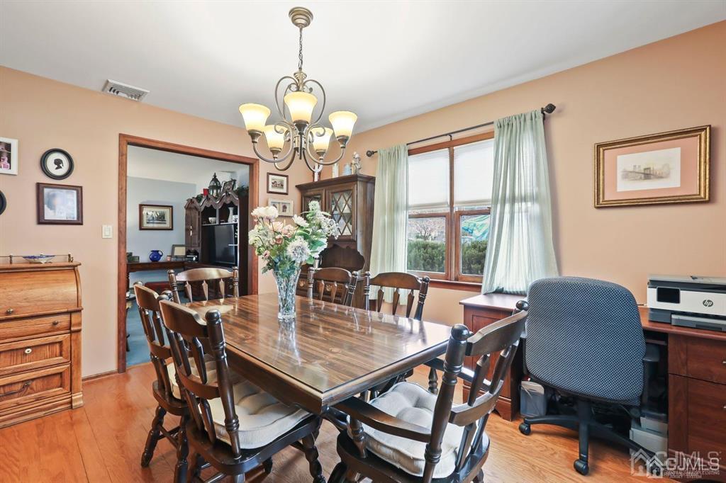 10 Bennett Road Old Bridge, NJ 07747 - Photo 6 of 35 a view of a dining room with furniture a chandelier and wooden floor