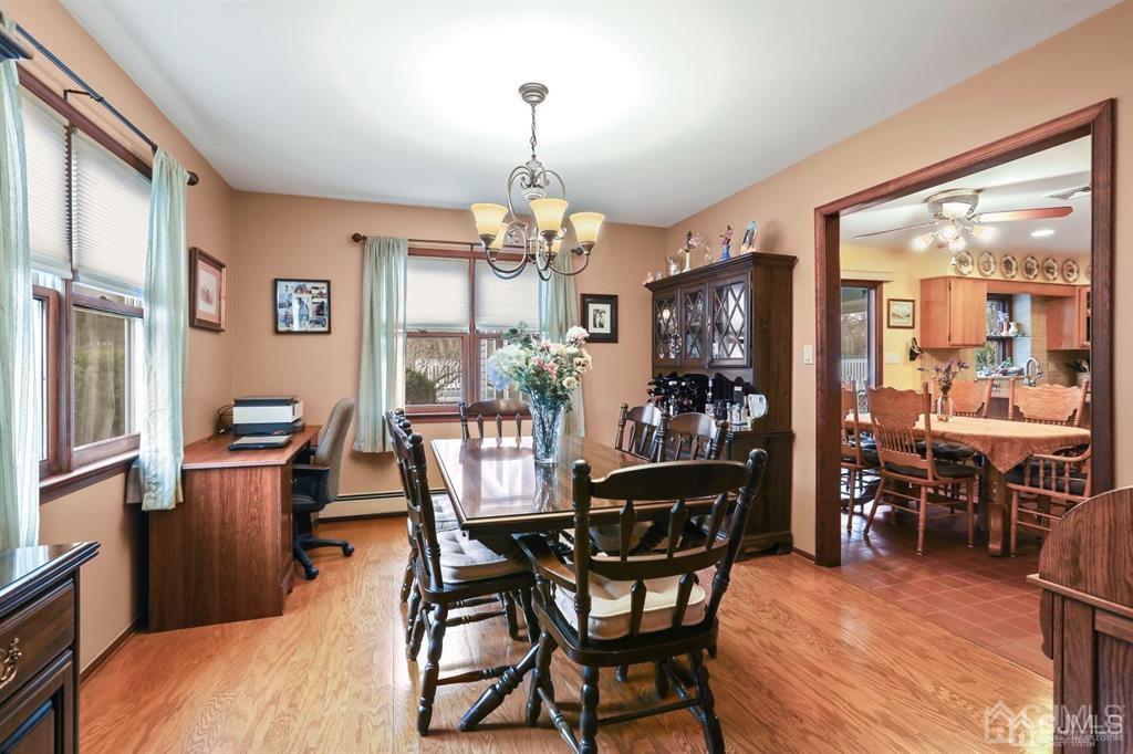 10 Bennett Road Old Bridge, NJ 07747 - Photo 7 of 35 a dining room with furniture a chandelier and wooden floor