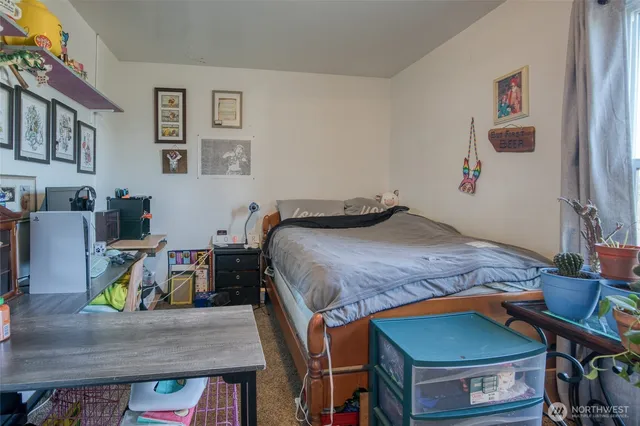 a bedroom with a bed and a table in it