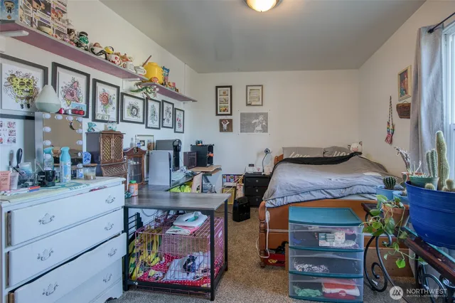a bed room with a bed and a computer on a desk