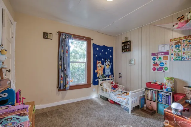 a children room with toys and a window