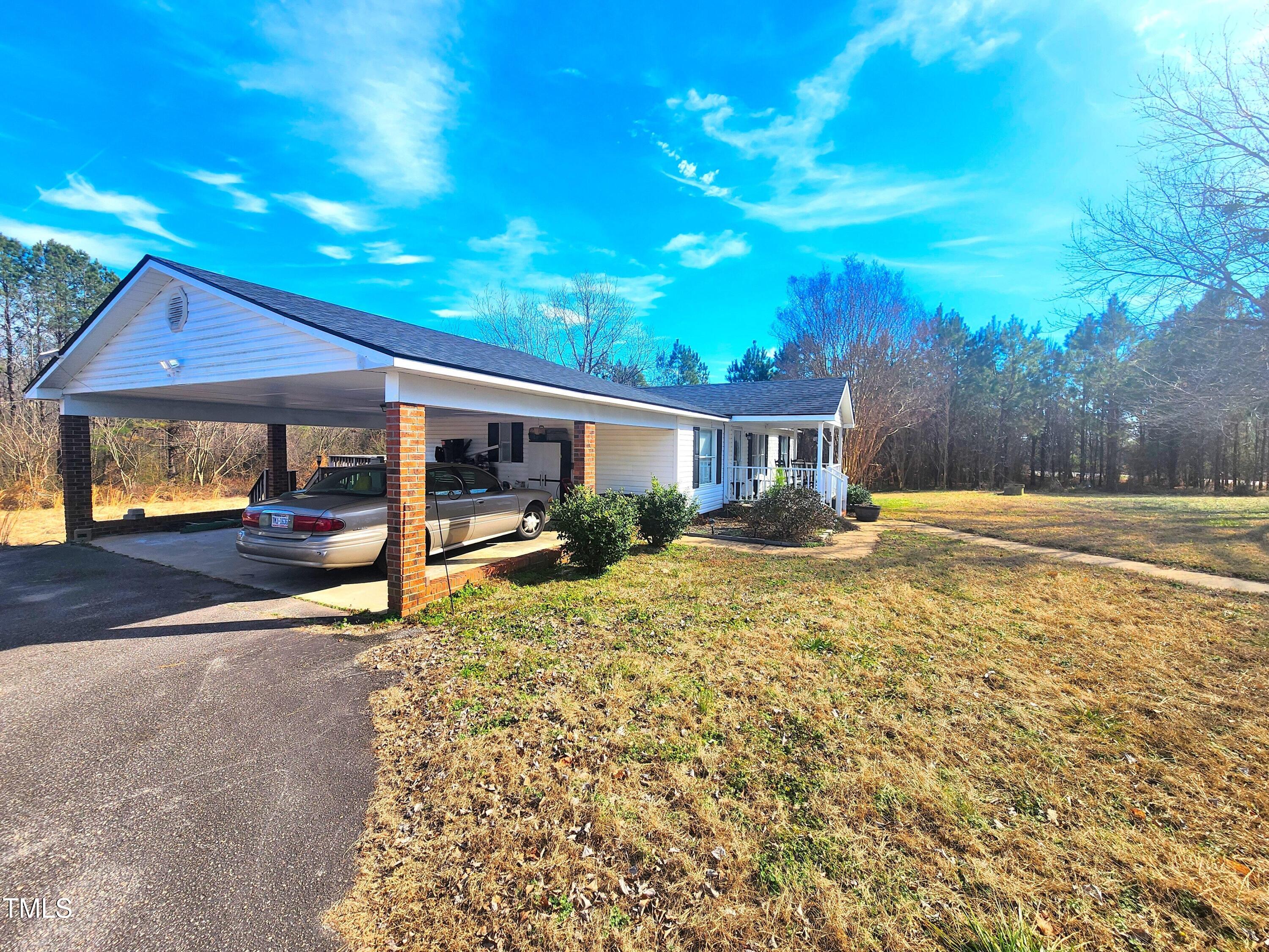 4101 Hopkins Road Middlesex, NC 27557 - Photo 2 of 17 a backyard of a house with table and chairs