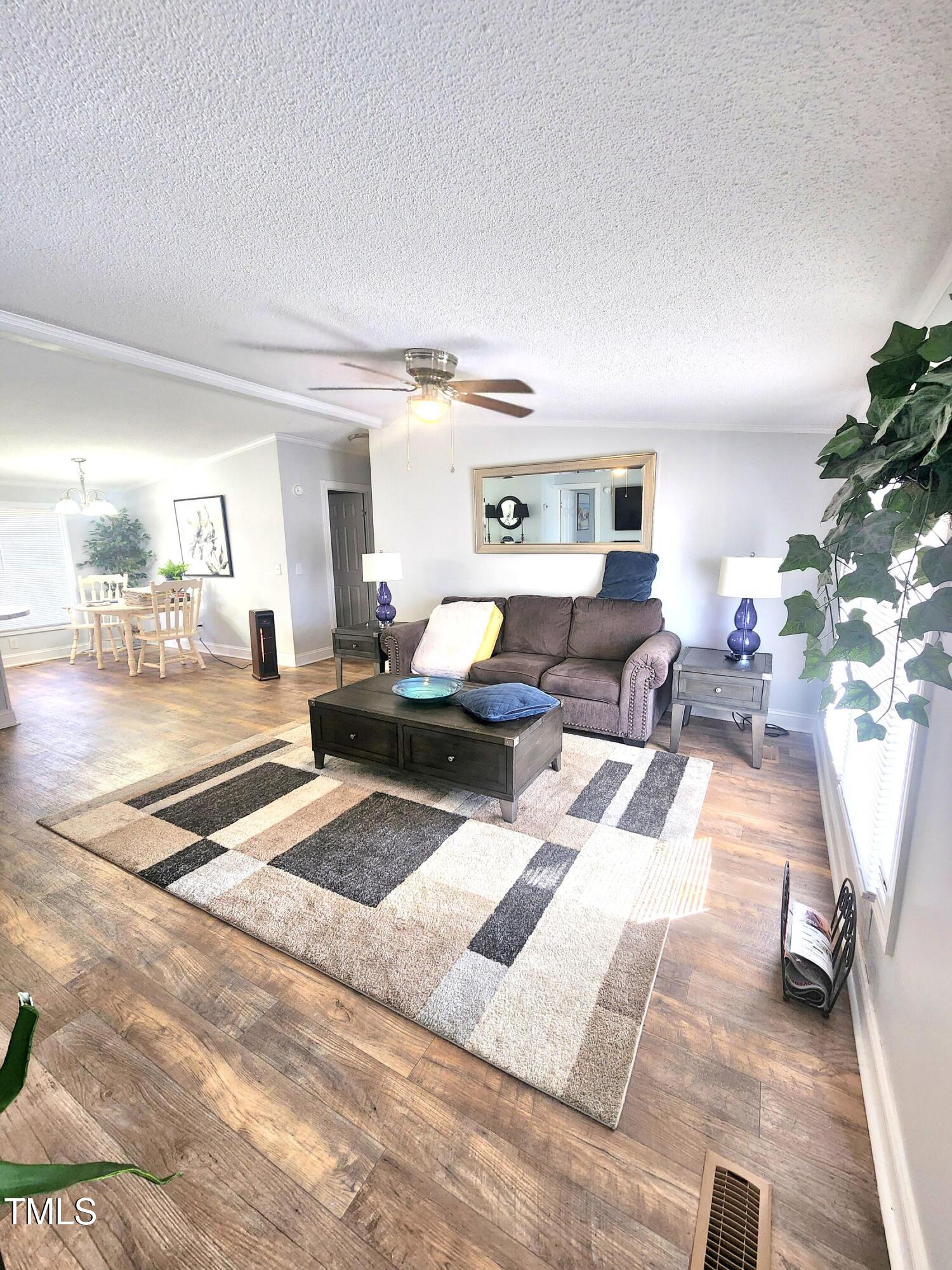 4101 Hopkins Road Middlesex, NC 27557 - Photo 4 of 17 a living room with furniture and a wooden floor