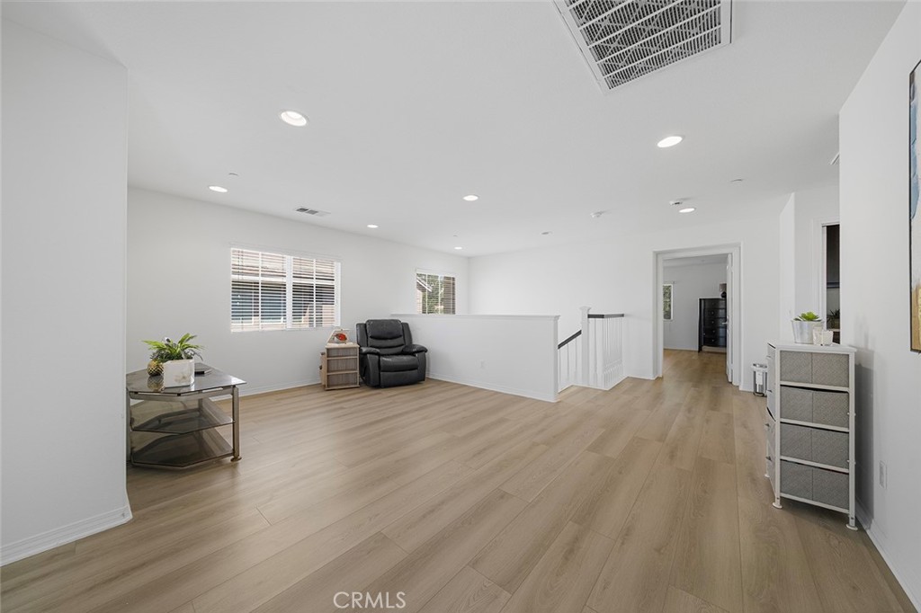 12936 Canopy Court Rancho Cucamonga, CA 91739 - Photo 16 of 30 a living room with furniture and a wooden floor