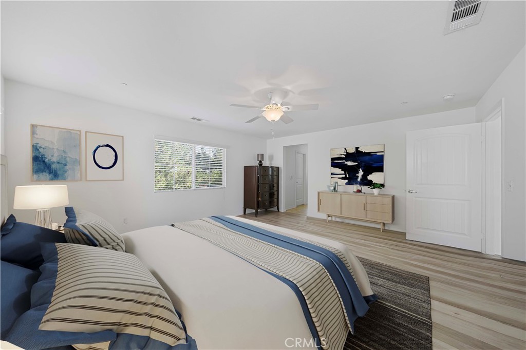 12936 Canopy Court Rancho Cucamonga, CA 91739 - Photo 19 of 30 a bedroom with a bed and a chandelier