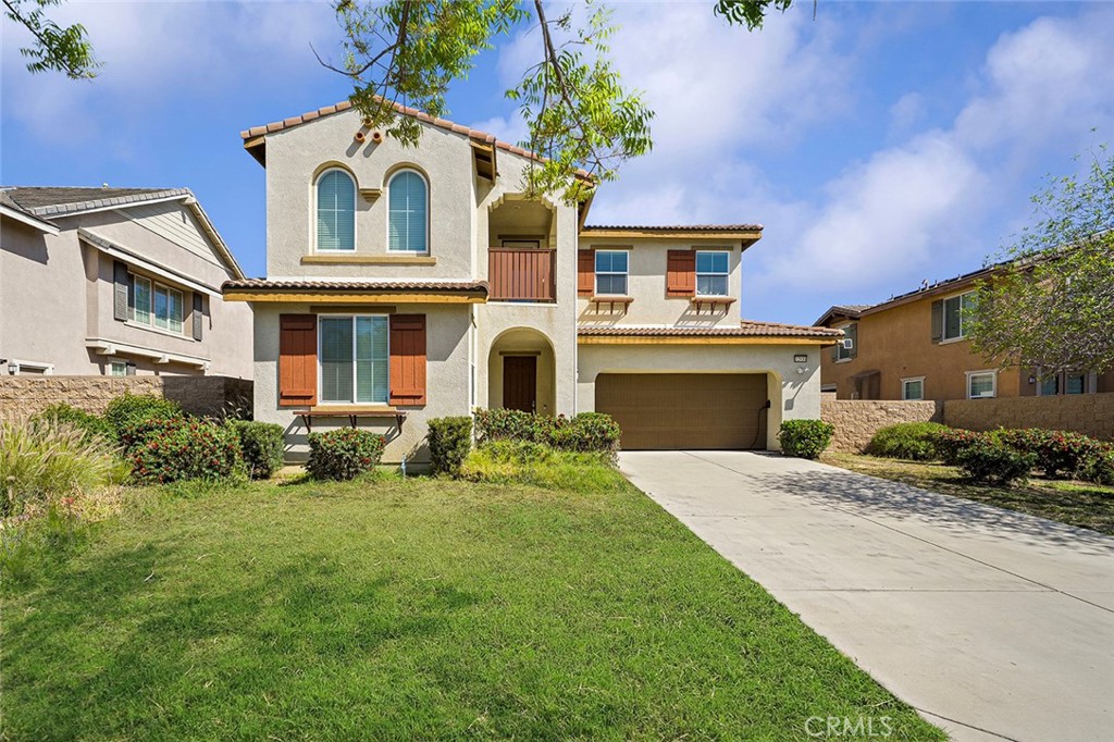 12936 Canopy Court Rancho Cucamonga, CA 91739 - Photo 2 of 30 a front view of a house with a yard and garage