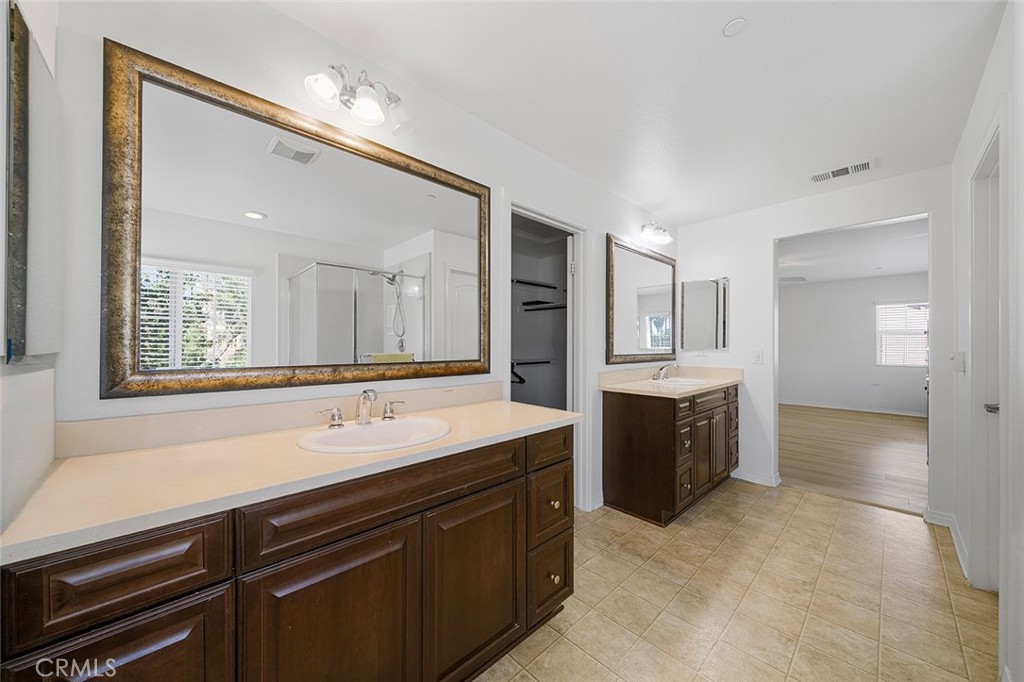 12936 Canopy Court Rancho Cucamonga, CA 91739 - Photo 22 of 30 a spacious bathroom with a sink a mirror a bathtub and window