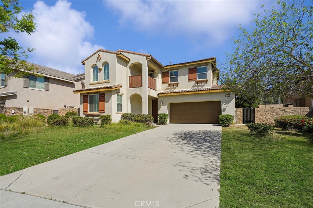 12936 Canopy Court Rancho Cucamonga, CA 91739 - Photo 3 of 30 a front view of a house with a yard and garage