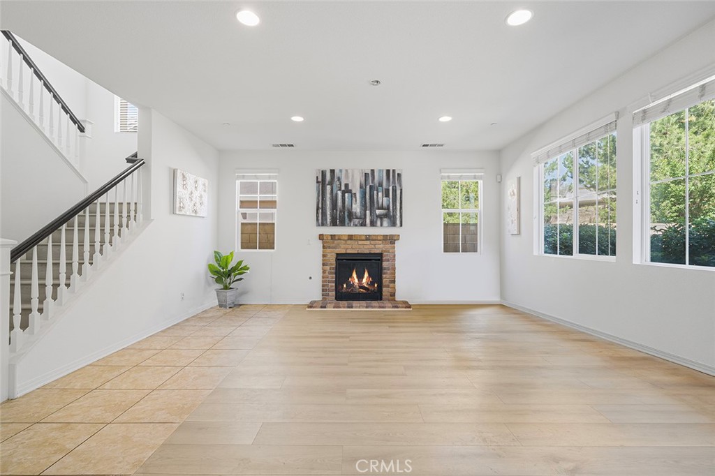 12936 Canopy Court Rancho Cucamonga, CA 91739 - Photo 5 of 30 a view of an empty room with a fireplace and a window