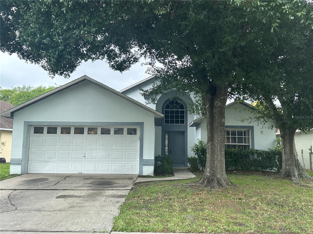 11606 Goodwyck Drive Orlando, FL 32837 - Photo 1 of 1 a front view of a house with a yard garage and outdoor seating