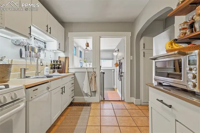 a large white kitchen with cabinets