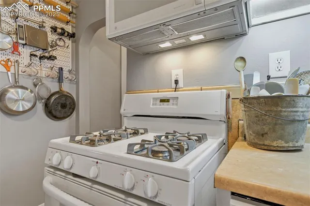 a kitchen with a stove and a white refrigerator
