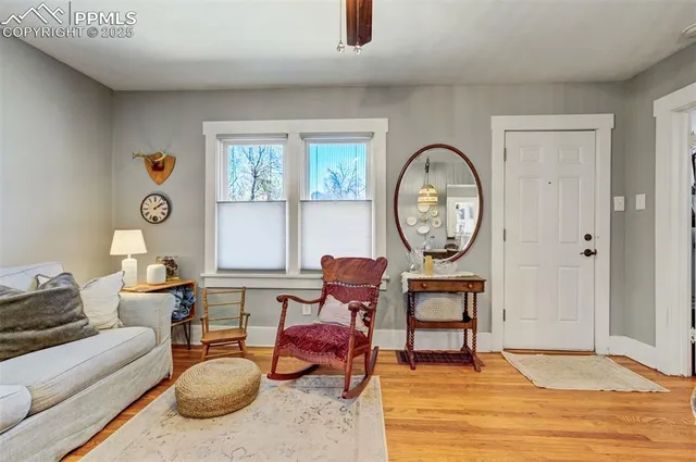 a living room with furniture a rug and a window
