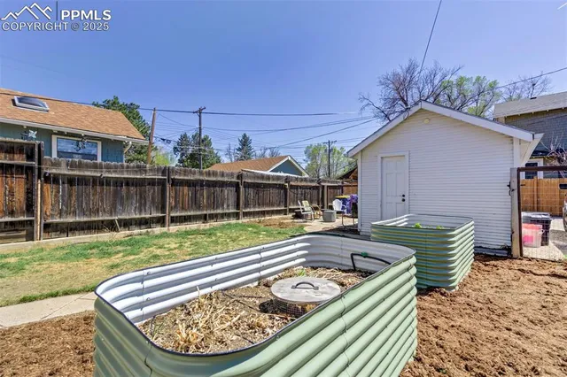a view of a backyard with couches chair and wooden floor