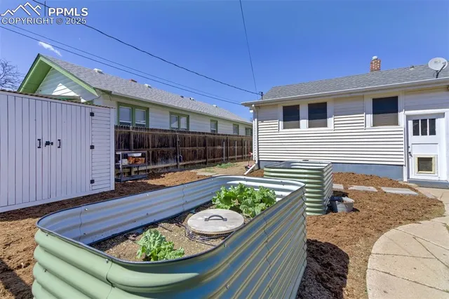 a view of a couches and table in backyard