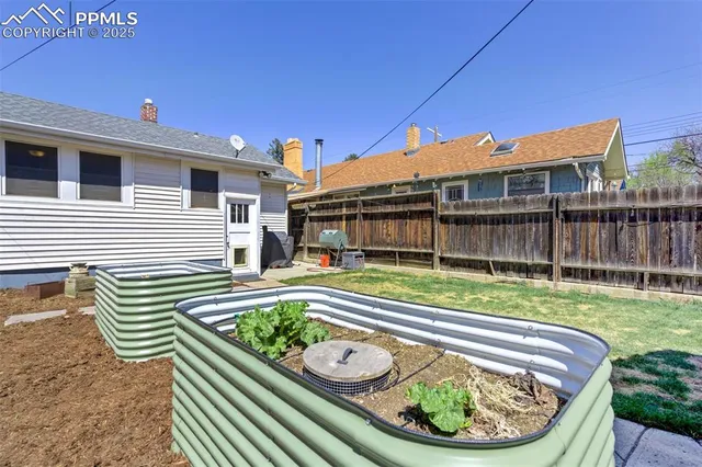 a view of a house with a backyard and a chair