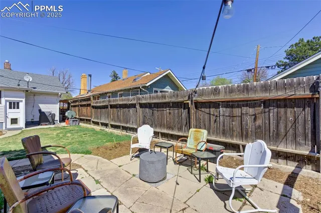a patio table and chairs with the garden view