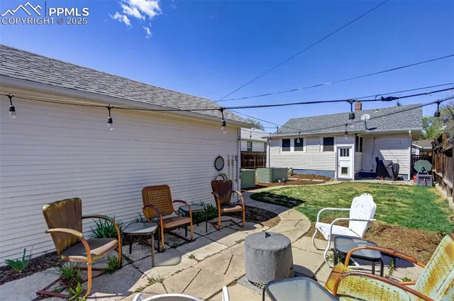 a backyard of a house with outdoor seating
