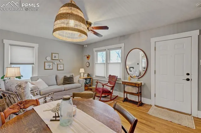 a living room with furniture a rug and a window