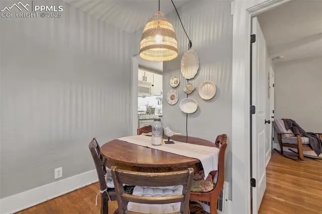 a dining room with furniture and wooden floor