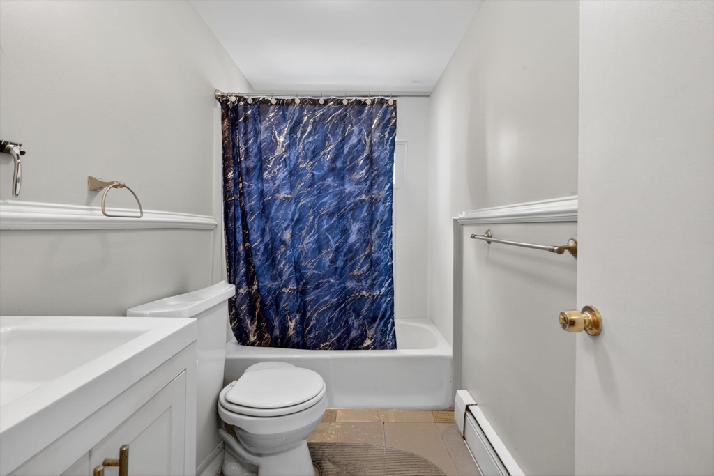 10-16 Stephen Street, Unit 5 Lynn, MA 01902 - Photo 13 of 26 a bathroom with a toilet and a shower curtain