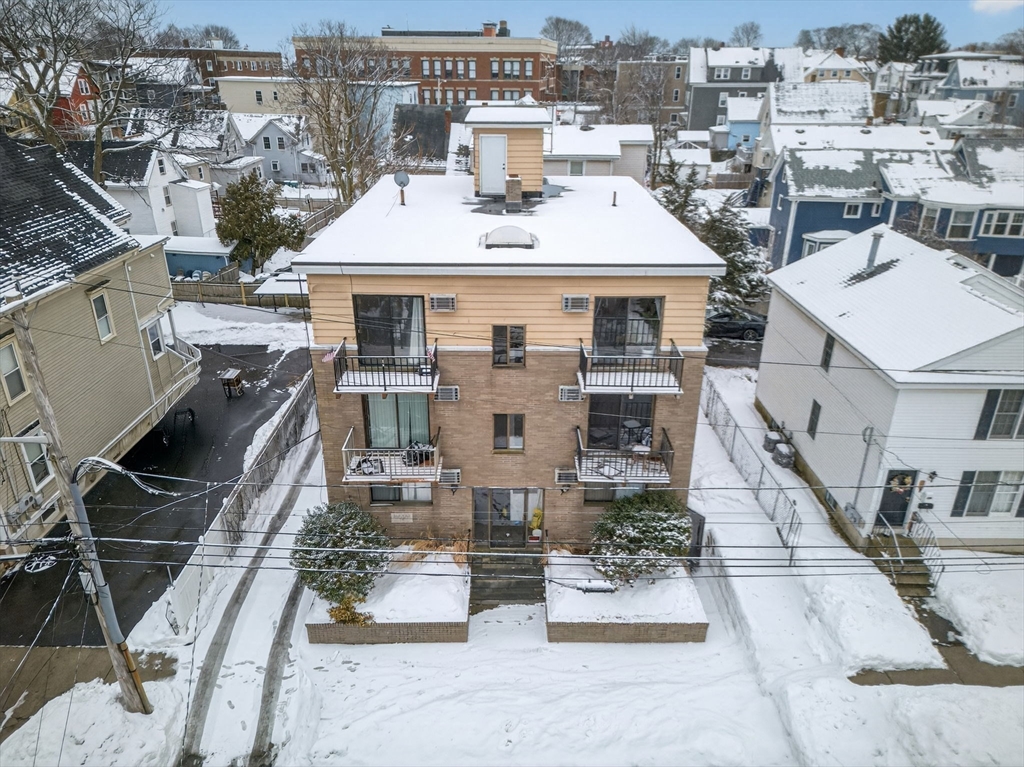 10-16 Stephen Street, Unit 5 Lynn, MA 01902 - Photo 19 of 26 a view of a house with pool and chairs