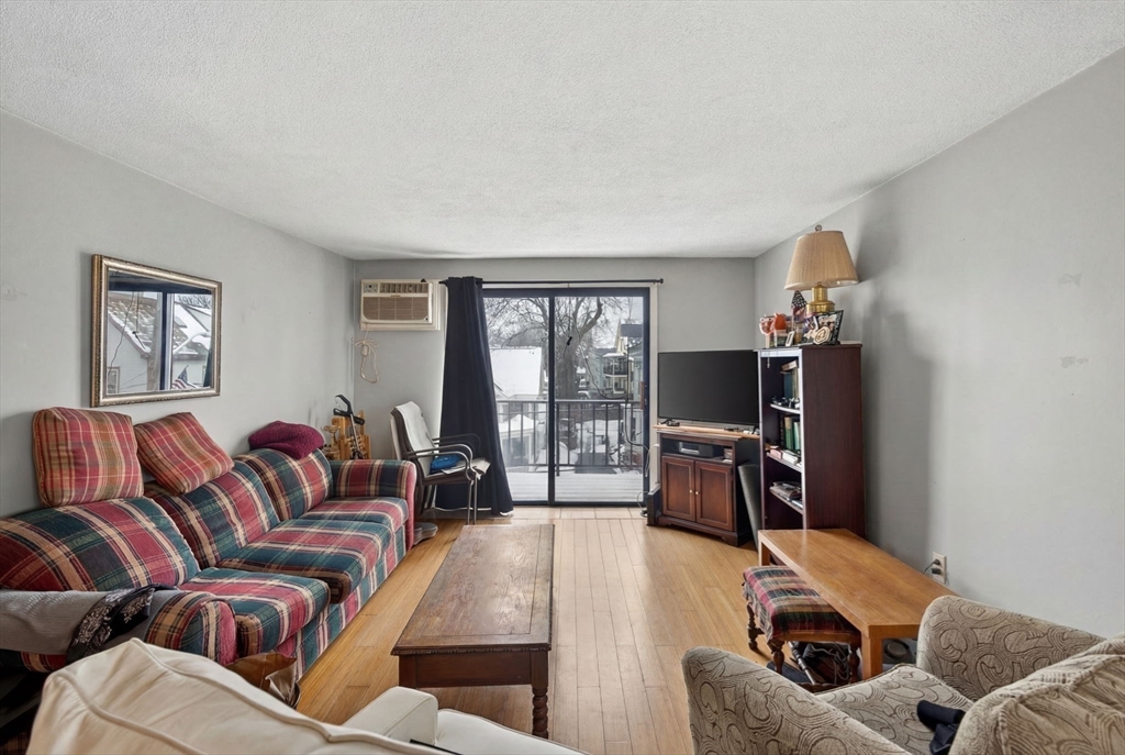 10-16 Stephen Street, Unit 5 Lynn, MA 01902 - Photo 9 of 26 a living room with furniture and a flat screen tv