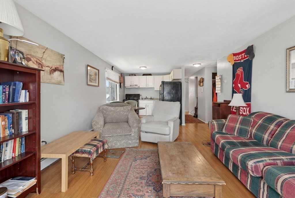 10-16 Stephen Street, Unit 5 Lynn, MA 01902 - Photo 10 of 26 a living room with furniture and a book shelf