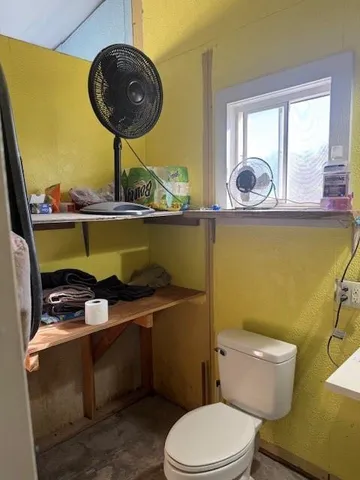 a bathroom with a toilet a sink and a mirror