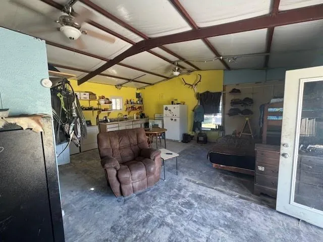 a living room with furniture and a mirror
