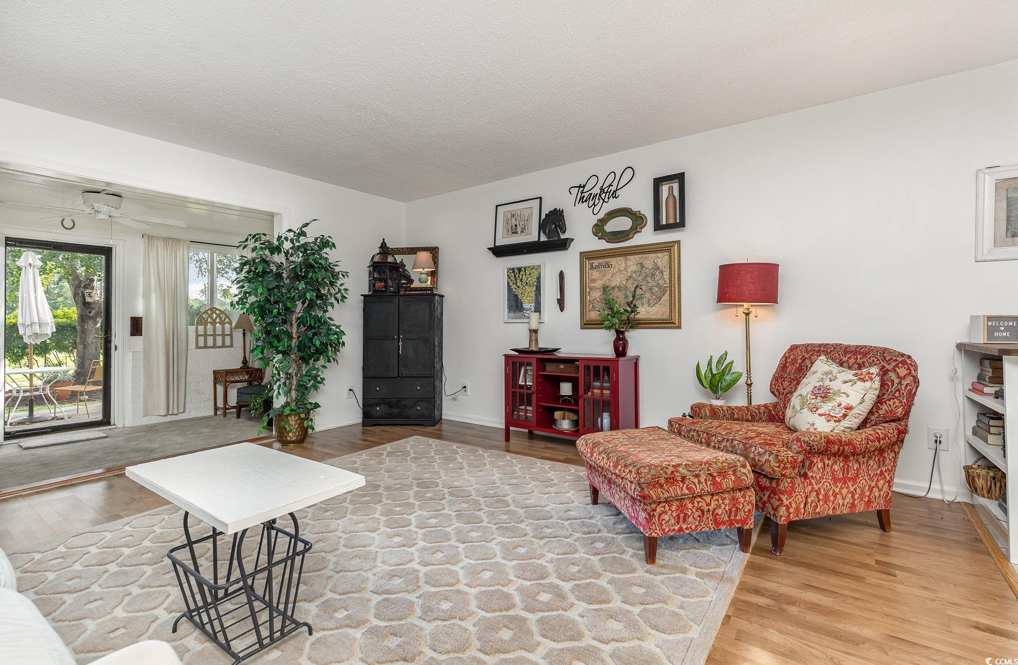 1830 Fairway Ridge Drive, Unit 6D Surfside Beach, SC 29575 - Photo 12 of 35 Living room featuring ceiling fan, light hardwood