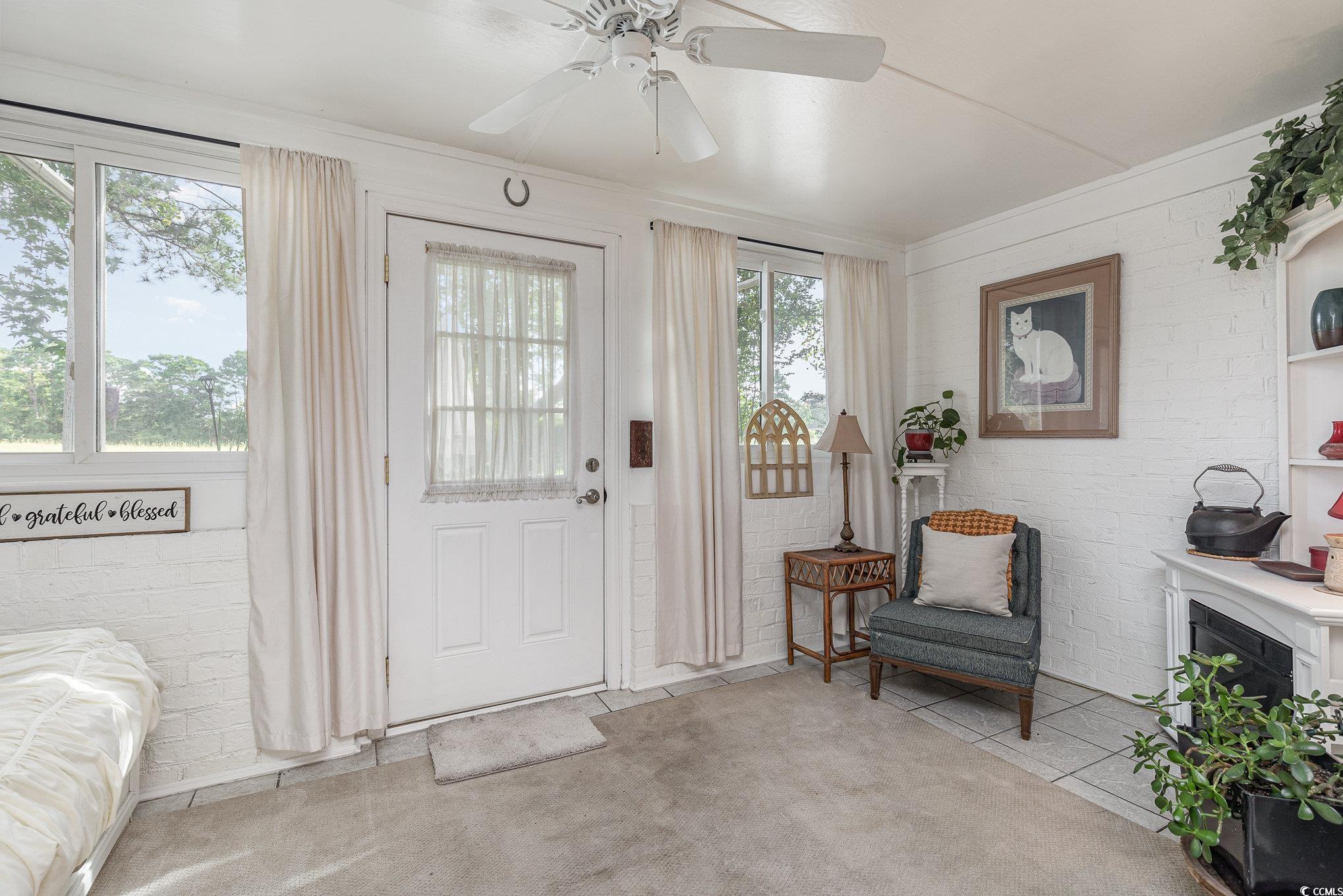 1830 Fairway Ridge Drive, Unit 6D Surfside Beach, SC 29575 - Photo 14 of 35 Back entrance with sealed brick, ceiling fan, and