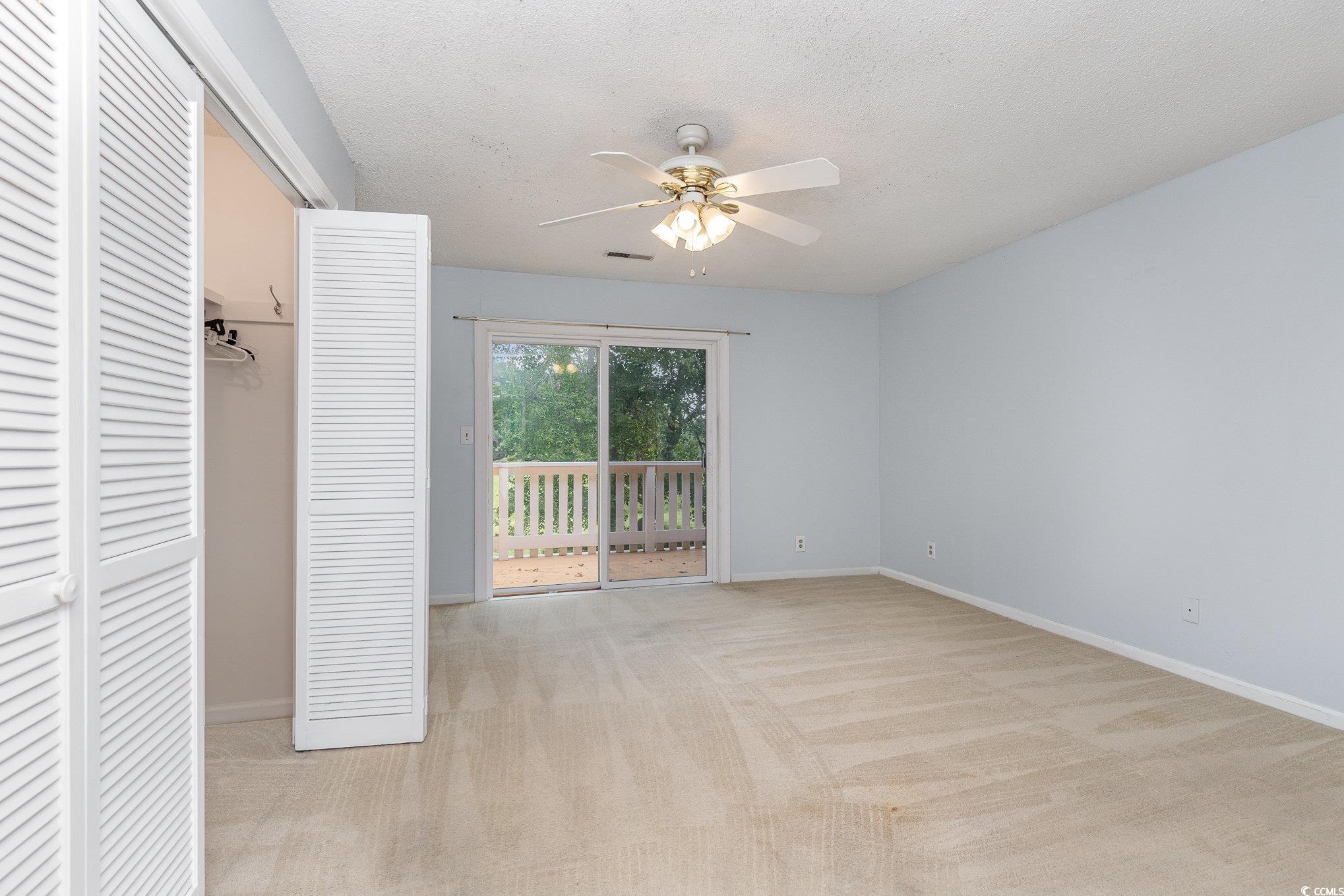 1830 Fairway Ridge Drive, Unit 6D Surfside Beach, SC 29575 - Photo 16 of 35 Bedroom with access to exterior deck, ceiling fan,