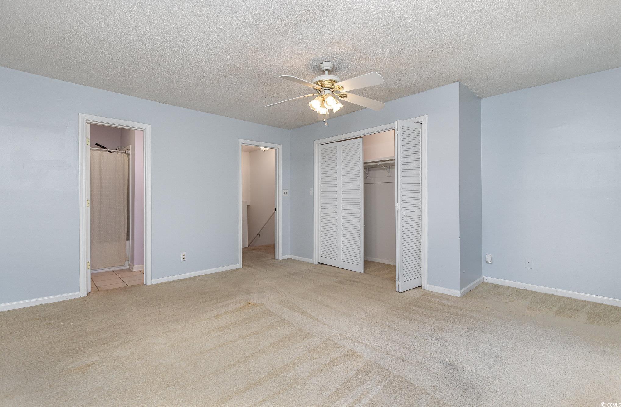 1830 Fairway Ridge Drive, Unit 6D Surfside Beach, SC 29575 - Photo 19 of 35 Bedroom with ceiling fan, light colored carpet, en
