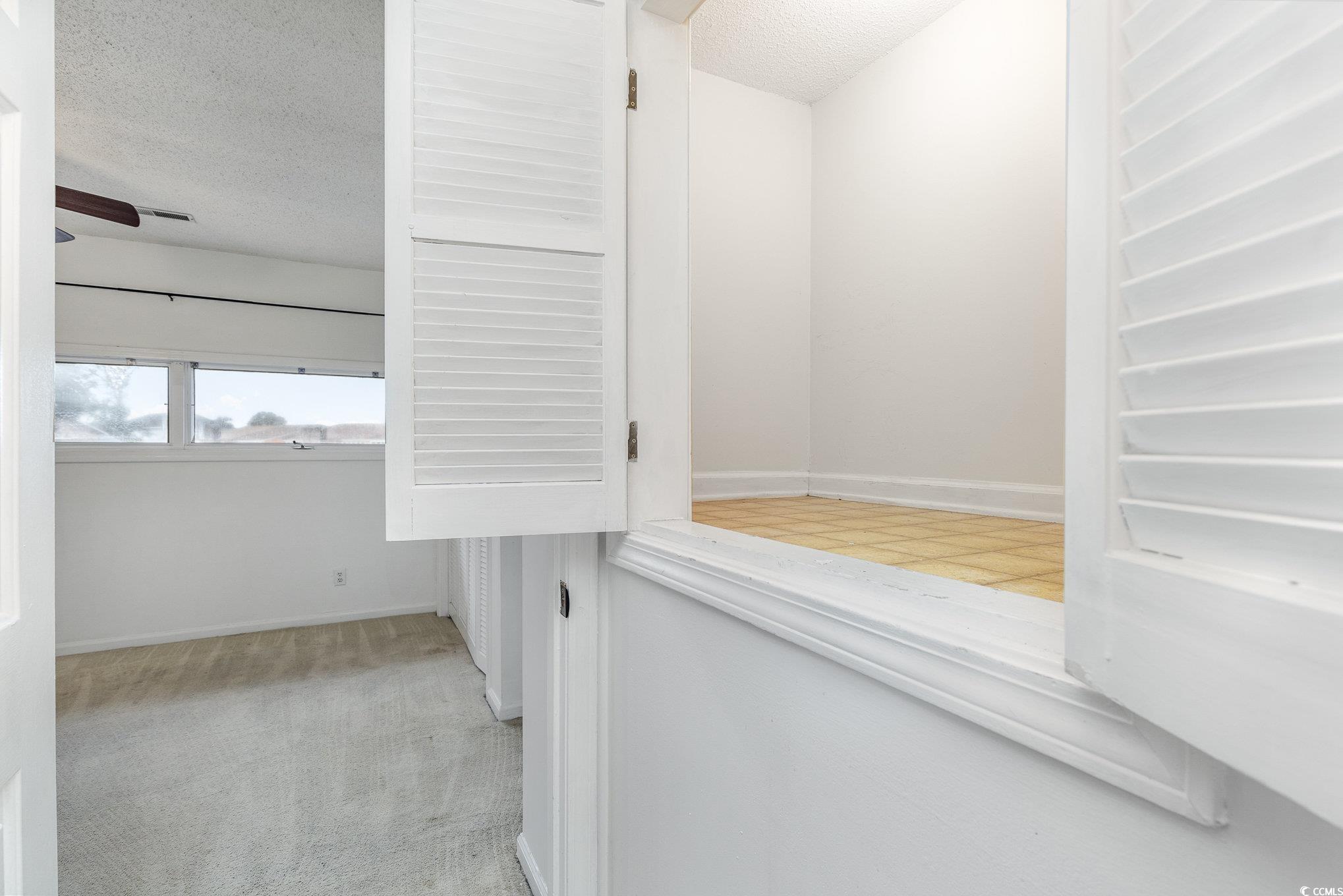 1830 Fairway Ridge Drive, Unit 6D Surfside Beach, SC 29575 - Photo 22 of 35 Corridor with a textured ceiling and light colored