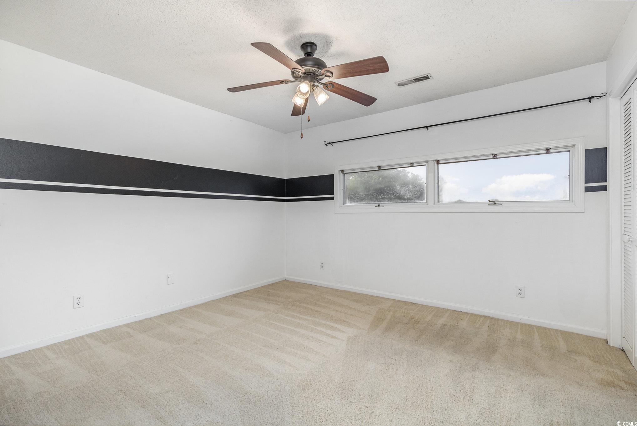 1830 Fairway Ridge Drive, Unit 6D Surfside Beach, SC 29575 - Photo 23 of 35 Bedroom featuring ceiling fan, light carpet, and e